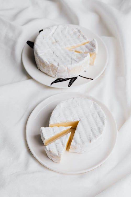 A Camembert Cheese on Ceramic Plates