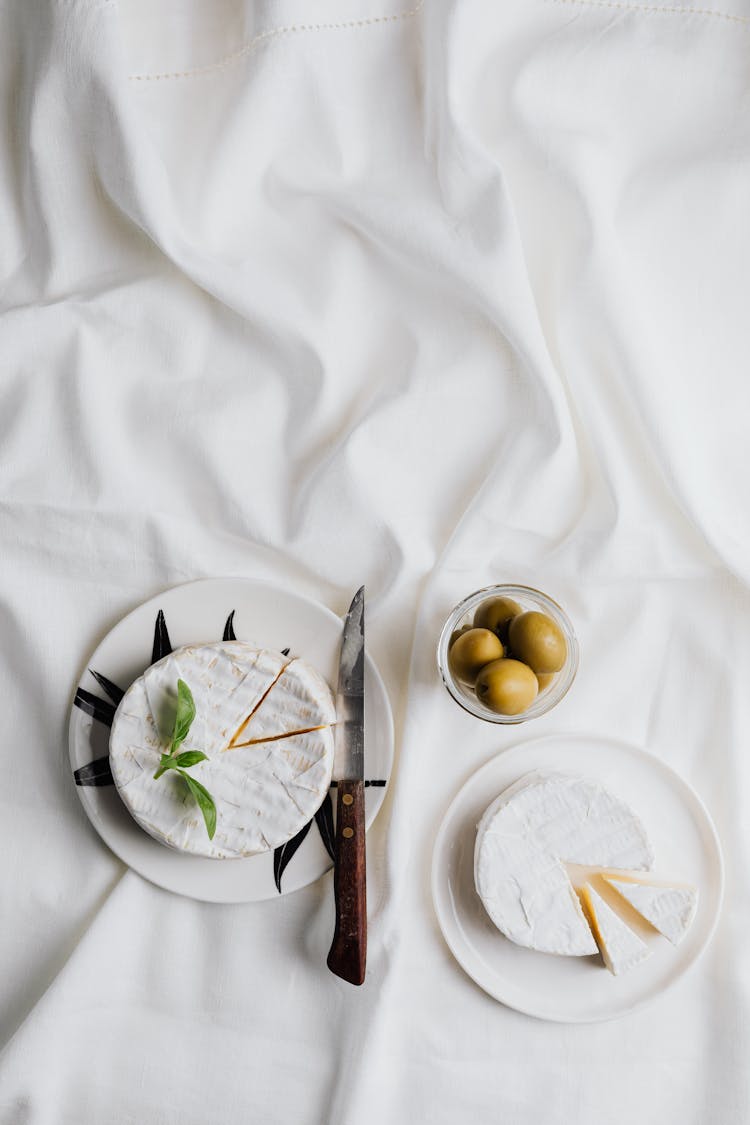 A Camembert Cheese Near The Olives