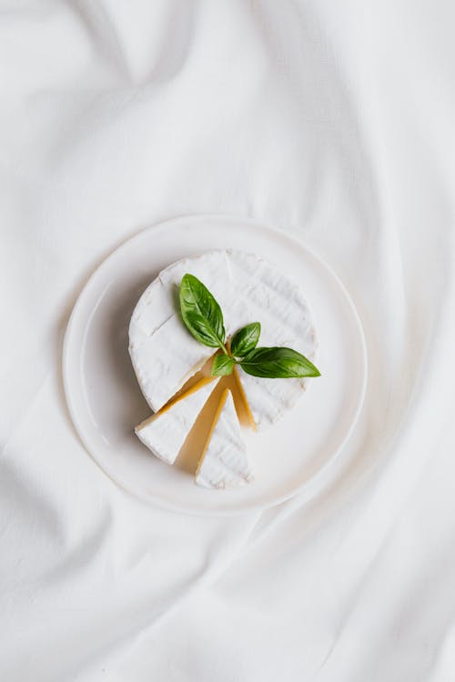 Sliced Cheese on a Plate Over a White Cloth