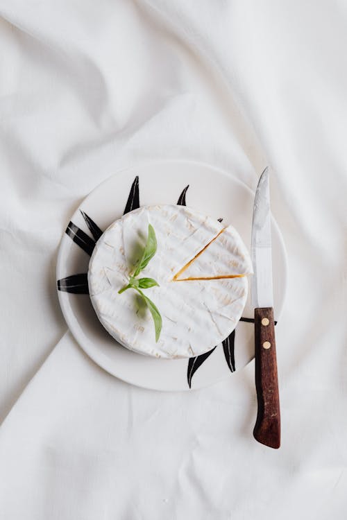 Sliced Cheese and Knife on a Plate