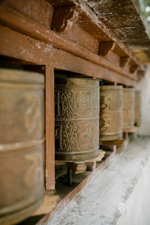 Old prayer wheels with ornament in Buddhist temple
