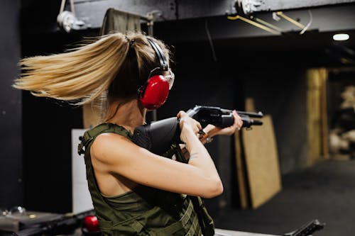A Woman Using a Shotgun in a Shooting Range