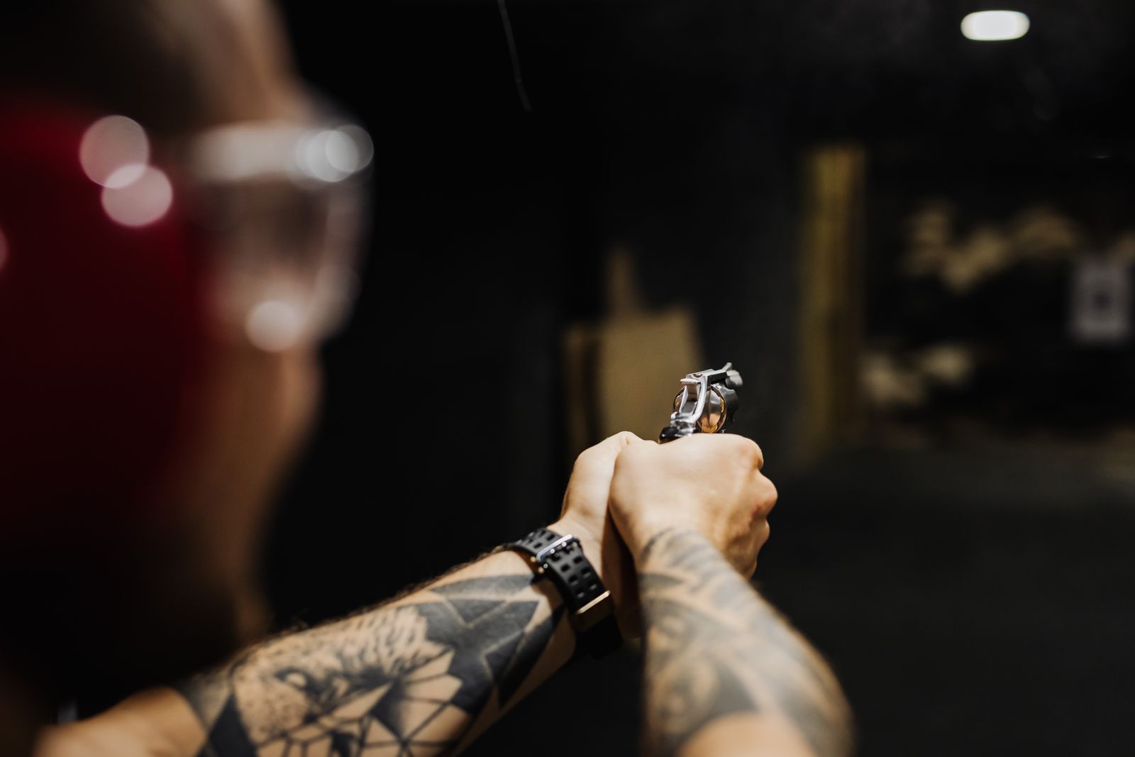 Shooter training at an indoor range under instruction