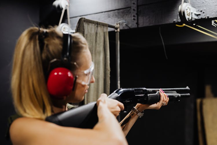 Woman Firing A Rifle