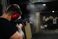 Man in Black T-shirt Holding Black Assault Rifle