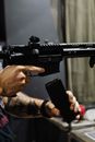 A Person Reloading a Rifle