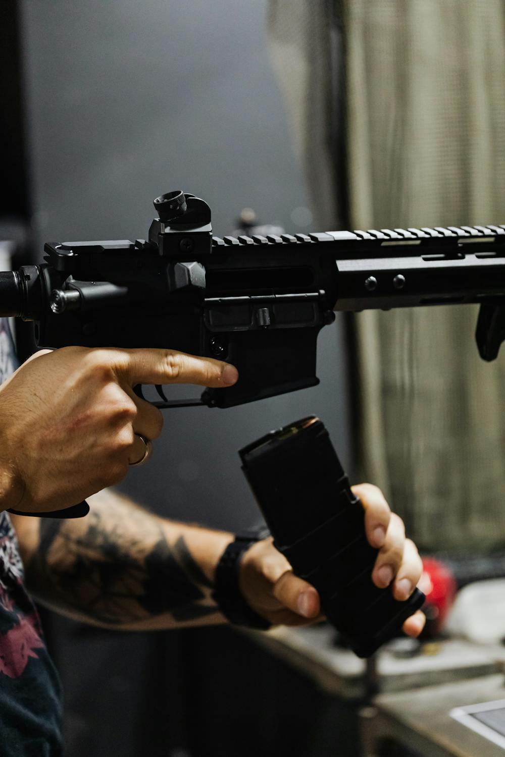 A Person Reloading a Rifle · Free Stock Photo