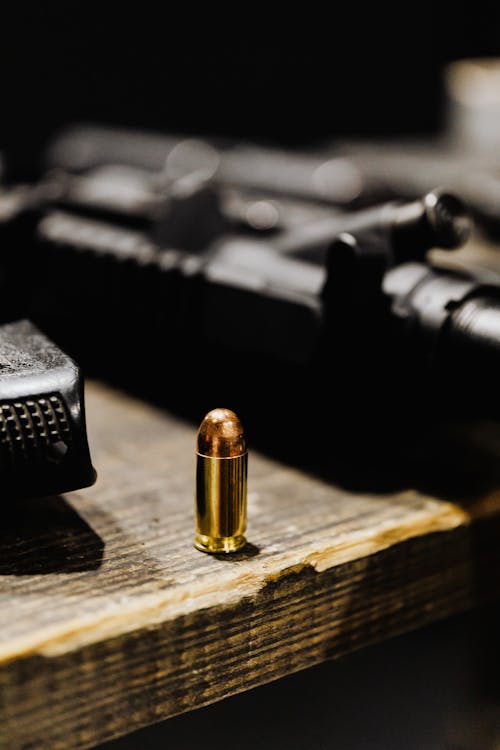 Free A Bullet on a Wooden Surface Stock Photo