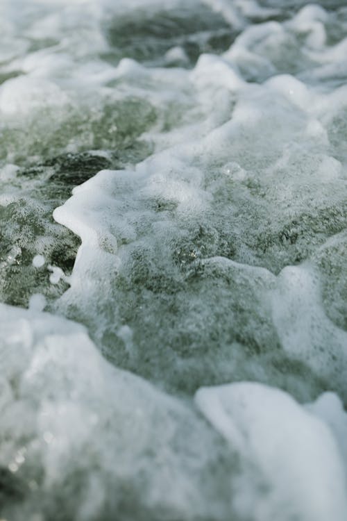 Sea Foam on the Body of Water 