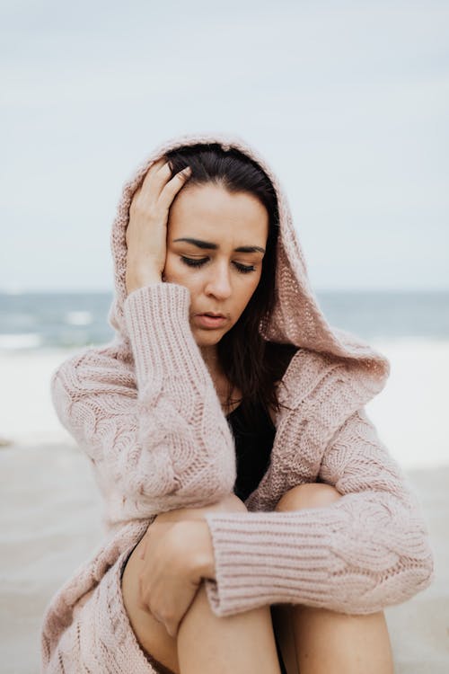 Free Woman in Knit Sweater on Beach Stock Photo
