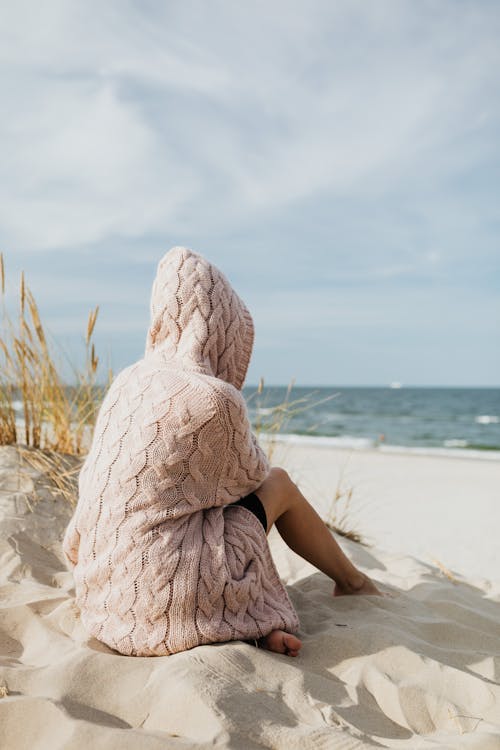 Free Back View of Barefooted Person Sitting on the White Sand  Stock Photo