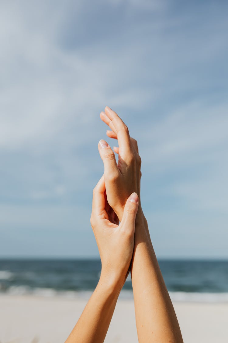 Person At The Beach Raising Hands 