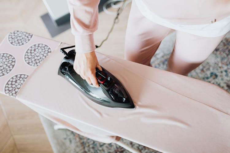 Person Ironing A Clothes 