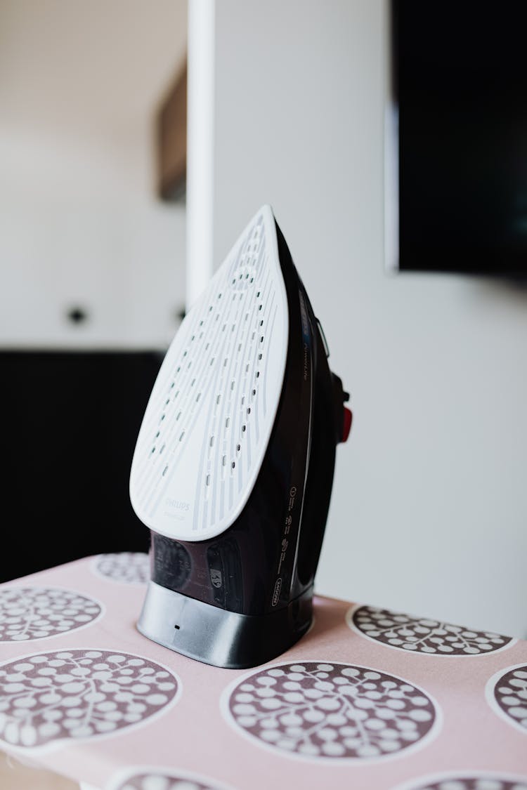 Black Clothes Iron On A Ironing Board