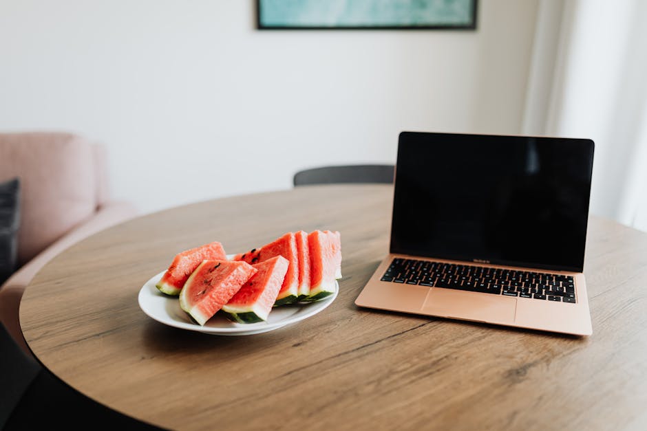 Does Baby-Led Weaning Help With First Foods? A cozy home office setup with watermelon slices and a laptop on a wooden table.