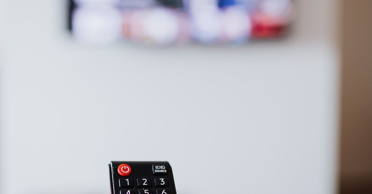 persons holding a red and black remote controllers ·... Person Holding a Black Remote Control · Free Stock Photo