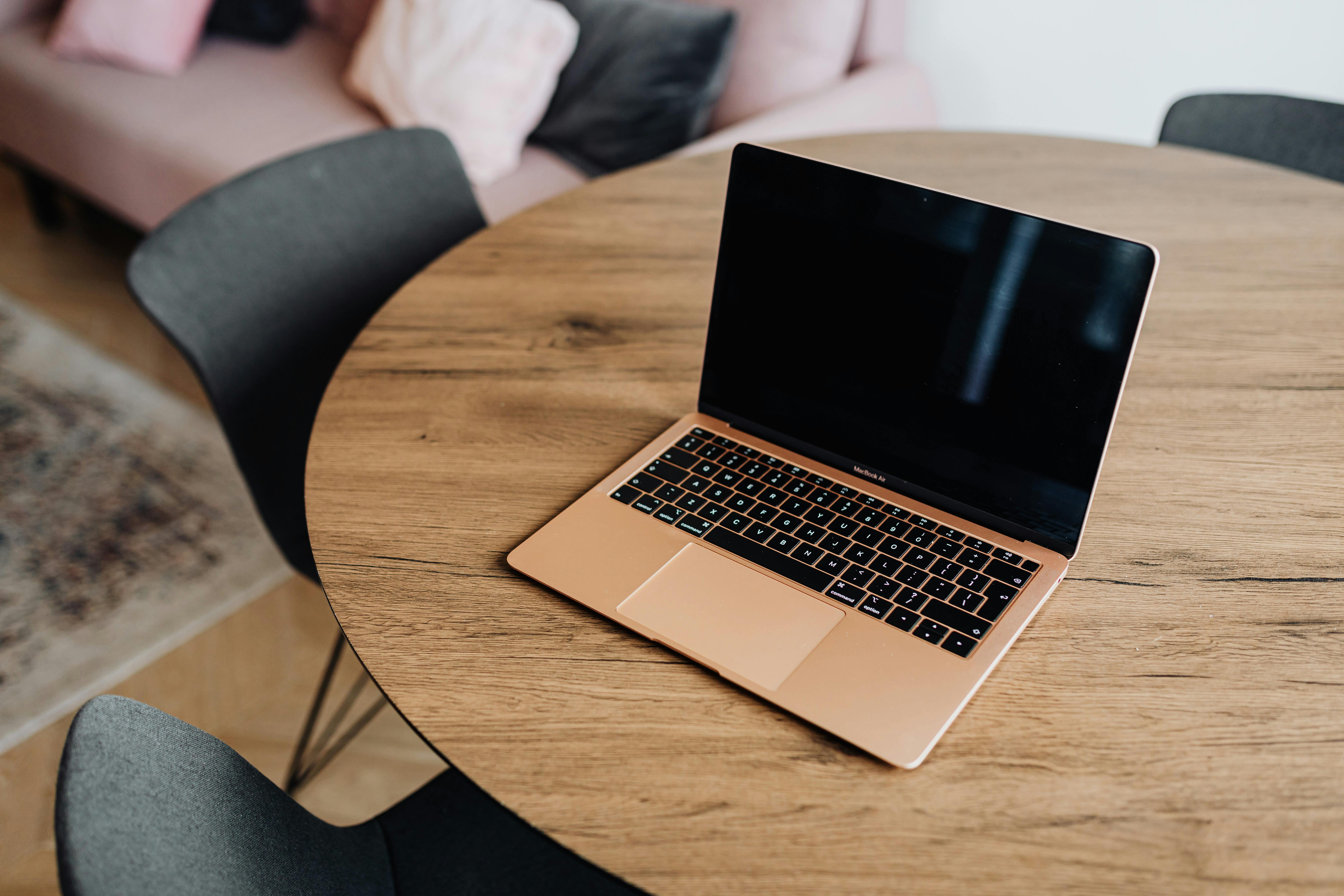 macbook pro on brown wooden table