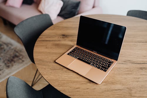 Macbook Pro on Brown Wooden Table