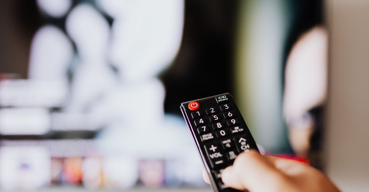 persons holding a red and black remote controllers ·... Person Holding a Black Remote Control · Free Stock Photo
