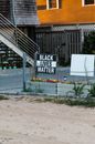 White and Black Wooden Signage