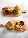Burger and Fries on Brown Wooden Chopping Board