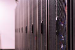 Row of similar lockers with various optic fiber cables in modern data server room