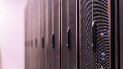 Row of similar lockers with various optic fiber cables in modern data server room