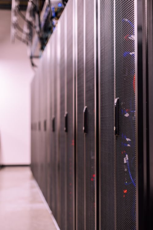 Fiber optic cables and connections in a server room representing hosting infrastructure