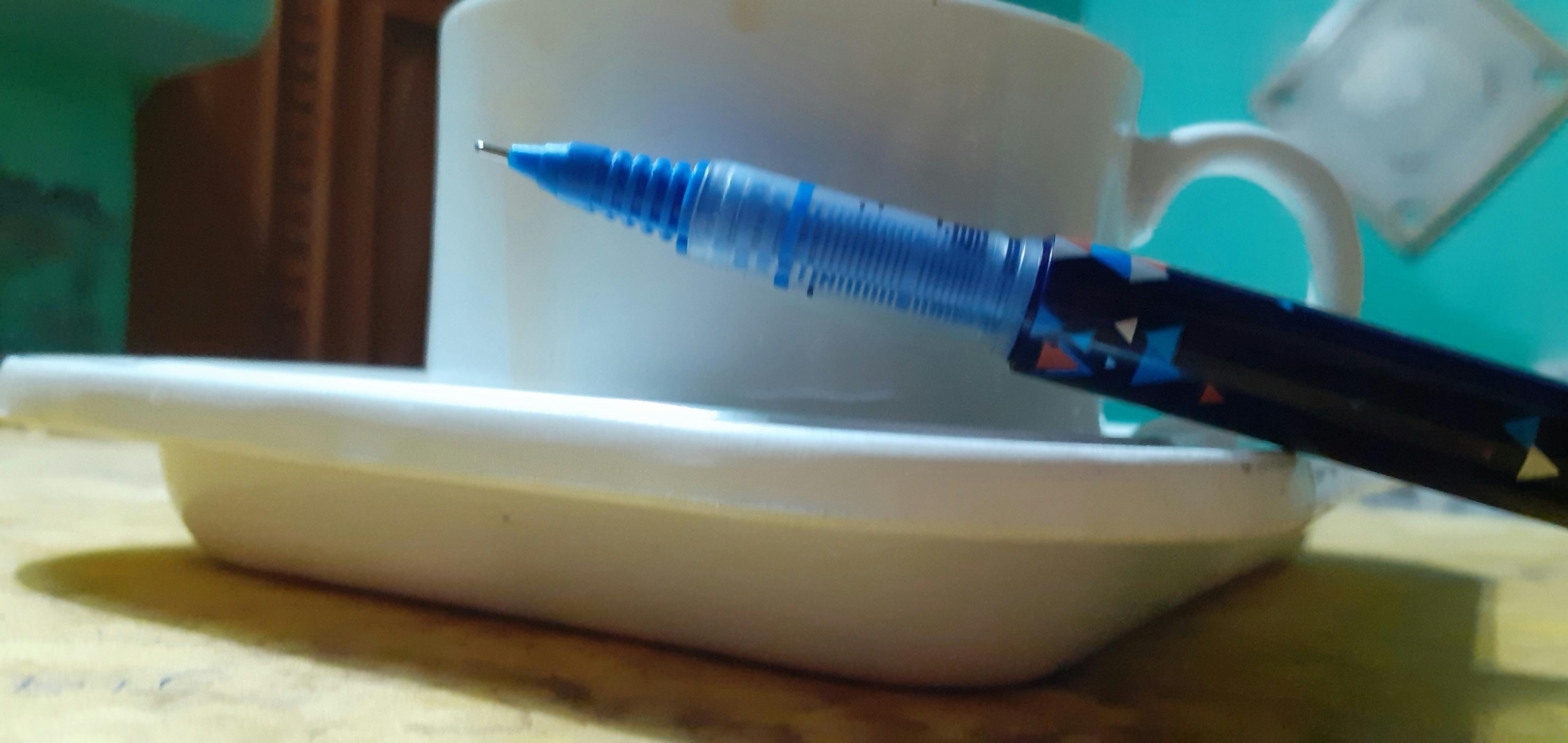 Person placing smartphone face down next to a notebook and pen, symbolizing a digital detox moment