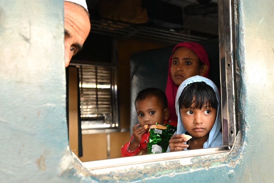 Children inside a train in Bangladesh looking outside, capturing travel curiosity.