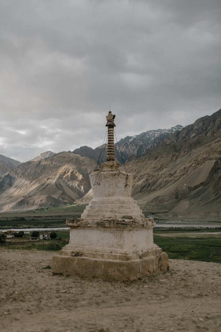 Ancient Buddhist Chorten In Wild Valley Against Misty Sky