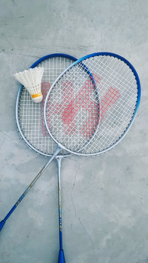 Free Badminton Rackets and Shuttlecock on Ground Stock Photo