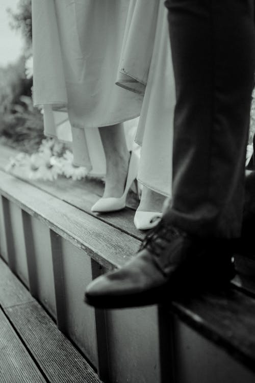 Grayscale Photo of Bride and Groom on Steps