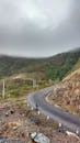 People Riding Motorcycle on Road Near Mountains