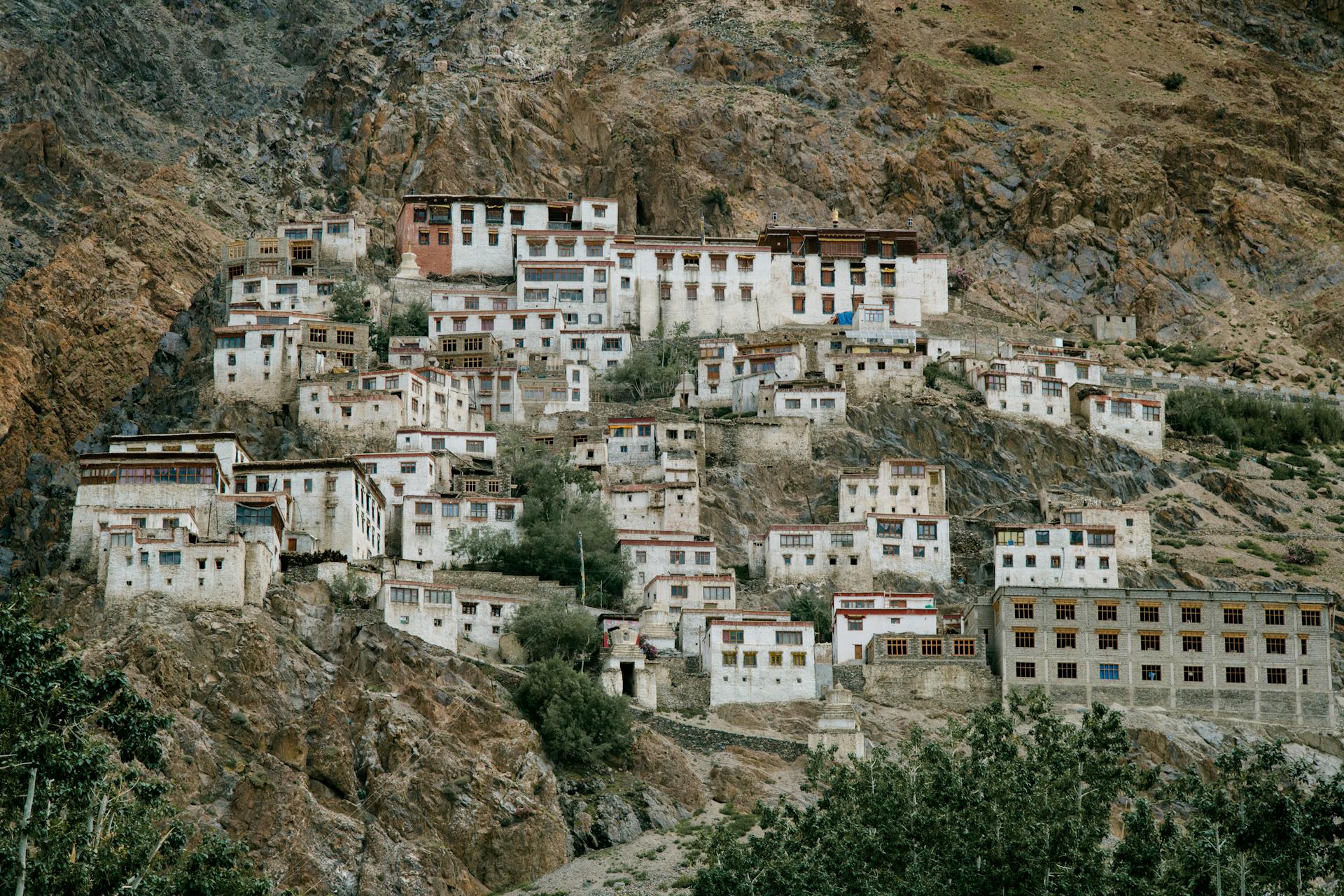 Ancient Tibetan monastery located on mountain slope in wild valley