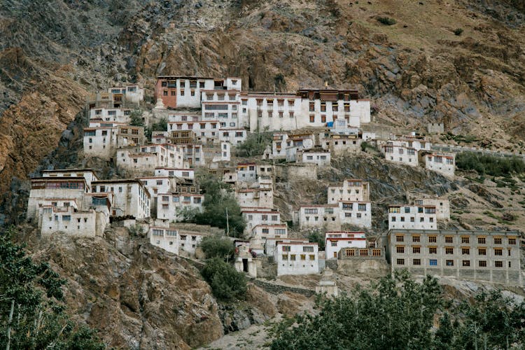 Ancient Tibetan Monastery Located On Mountain Slope In Wild Valley