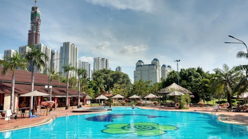 Swimming Pool Near Green Trees and High Rise Buildings