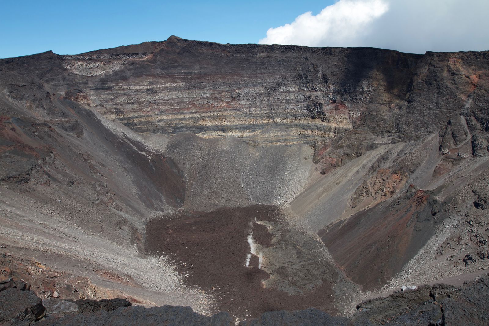 A volcanic peak rising above forested slopes on a tropical island