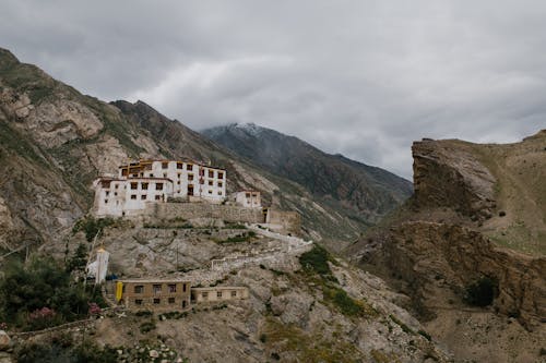 Picturesque mountainous valley with ancient Buddhist monastery on cloudy day