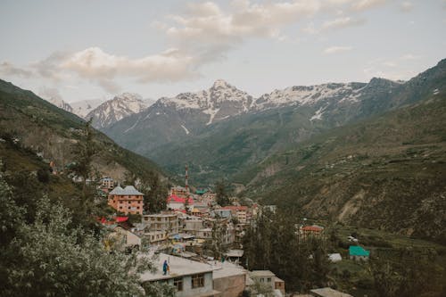 Old town surrounded by mountains against cloudy sundown sky