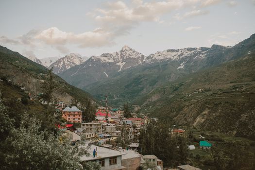 From above of small residential buildings located on mountain slope in Manali resort town in India