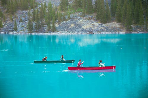People sailing in boats on colorful lake