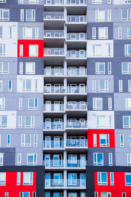 Facade of high rise residential building with colorful walls located in city in daytime