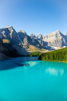 Picturesque scenery of calm turquoise water of river flowing among rocky mountains in sunny day