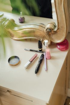 A beautifully arranged vanity table featuring various cosmetic products and a vintage mirror, perfect for beauty inspiration.