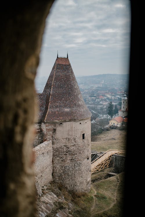 Free From above of tower of medieval stone Corvin Castle against cloudy sky built in Hunedoara in Gothic Renaissance architectural style Stock Photo