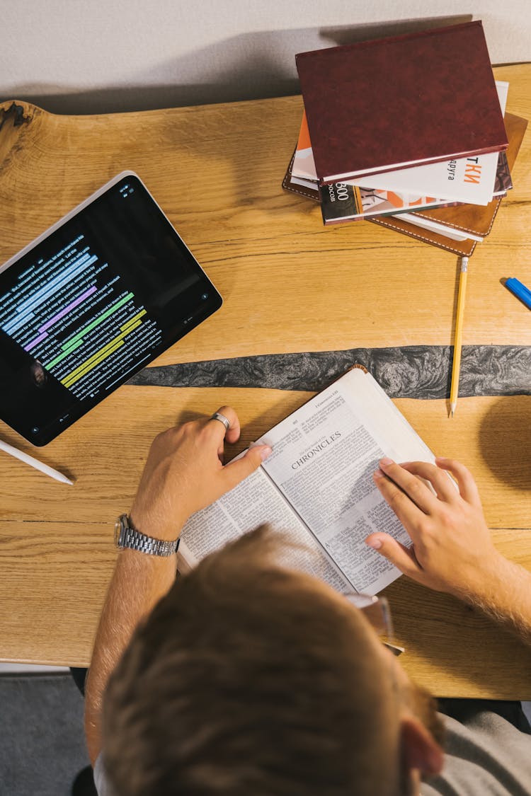 A Person Reading A Bible