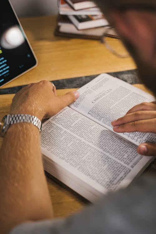 Free Close-Up Shot of a Person Reading a Bible Stock Photo
