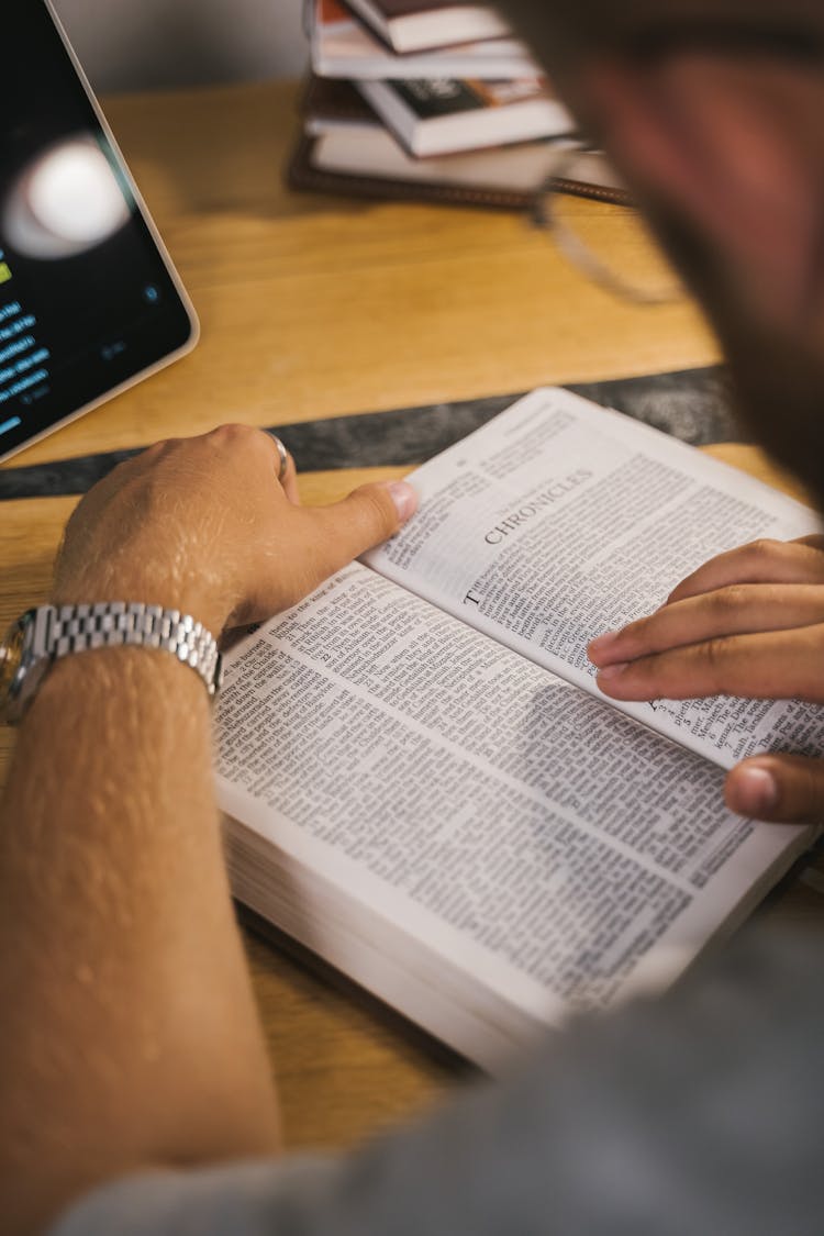 Close-Up Shot Of A Person Reading A Bible