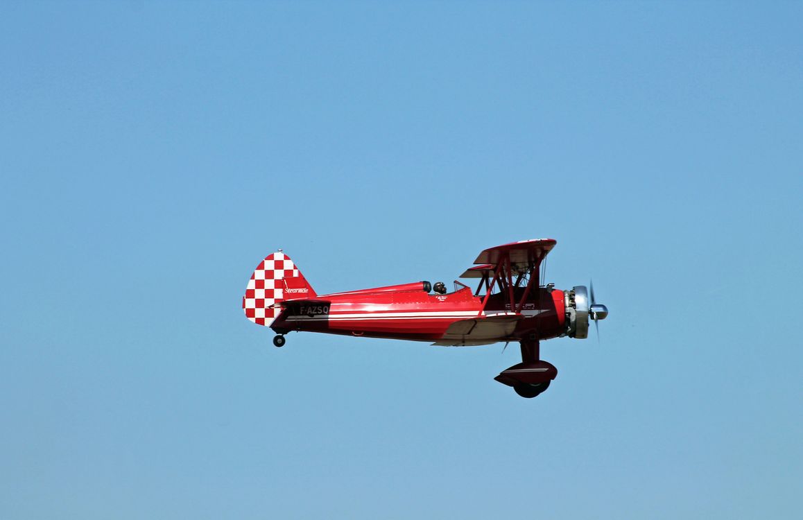 Close-Up Shot of a Flying Red Biplane · Free Stock Photo